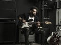 Man playing his electric guitar in a music studio Royalty Free Stock Photo