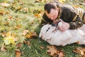 Man playing with his saint bernard dog in the autumn park