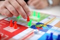 Man is playing ludo board game