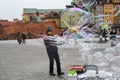 Man playing with making soap ballons in Warsaw city