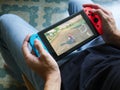 A man playing Mario Kart 8 Deluxe on Nintendo Switch.