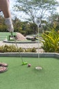 Man Playing Mini Golf with Gloves