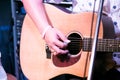 Man playing music at black wooden acoustic guitar.Focus on fingers Royalty Free Stock Photo