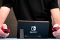 Man playing Nintendo Switch video game console indoors