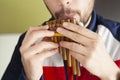 Man Playing pan flute at home Royalty Free Stock Photo