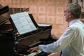 Man playing piano in a cathedral Royalty Free Stock Photo