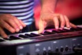 The man playing on piano in scenic illumination