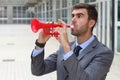 Man playing a plastic trumpet in the office