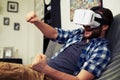 Man playing racing game using virtual reality headset Royalty Free Stock Photo