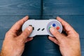 Man playing retro video game with controller dark background