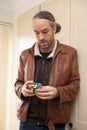 A man playing with a Rubix cube Royalty Free Stock Photo
