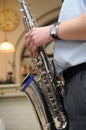 Man playing sax or brass horn (musical instrument)
