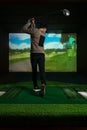 A man playing screen golf. Golf Simulator.