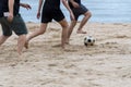 Man playing soccer on the beach and footprint on the sands