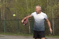 Man playing tennis on the outdoor court