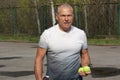 Man playing tennis on the outdoor court