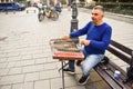 Man playing traditional hammered dulcimer with mallets. Street artist plays songs on the Bucharest`s streets in downtown. Royalty Free Stock Photo