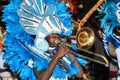 Man playing trombone in a traditional costume during a Junkanoo parade in the Bahamas. Royalty Free Stock Photo