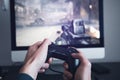 Man playing video game. Hands holding console controller. Royalty Free Stock Photo