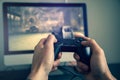 Man playing video game. Hands holding console controller. Royalty Free Stock Photo