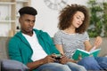 man playing video games while woman reading book Royalty Free Stock Photo