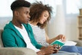 man playing video games and woman reading book Royalty Free Stock Photo