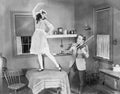 Man playing violin for woman dancing on table