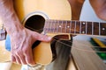 man plays acoustic guitar, close-up hands, strings hanging freely, guitar tuning, concept of creativity, guitar lessons, replacing Royalty Free Stock Photo