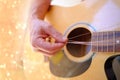 man plays acoustic guitar, close-up hands, strings hanging freely, guitar tuning, concept of creativity, learning, guitar lessons