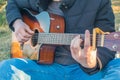 A man plays acoustic guitar. Rest on the open air