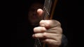 Man plays the bass guitar. Dark background. slowmo Royalty Free Stock Photo