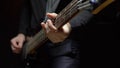 Man plays the bass guitar. Dark background. slowmo Royalty Free Stock Photo