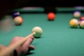 A man plays billiards in a bar. snooker, man aiming at the cue ball Royalty Free Stock Photo