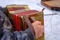 a man plays a bright harmonica on the street in winter, a street musician. An ancient musical instrument Royalty Free Stock Photo