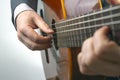 Man plays the classical guitar on a white background. musical creativity. string musical instrument