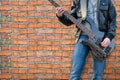 Man plays electric guitar on the background brick wall Royalty Free Stock Photo