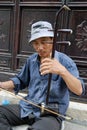 Man plays erhu, a traditional chinese instrument