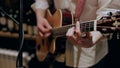 A man plays on the guitar and changes chords