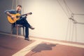 Man plays a guitar, interior