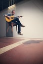 Man plays a guitar, interior