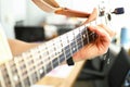 Man plays guitar, male hand holds neck guitar Royalty Free Stock Photo