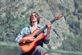 Man plays the guitar in nature Royalty Free Stock Photo