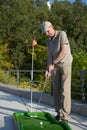 Man plays minigolf Royalty Free Stock Photo