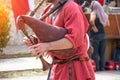 A man plays a musical bagpipe, a close up view