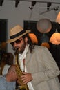 Man plays the saxophone on show with hoops at private party in Ibiza, Spain. Royalty Free Stock Photo