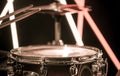 A man plays with sticks on a musical percussion instrument, close-up. On a blurred background of colored lights. Royalty Free Stock Photo