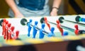 Man plays table football. Detail of man`s hands playing the kicker Royalty Free Stock Photo