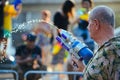 A man plays water with his water gun during Songkran