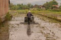 A man plows a village rice field on Java after harvesting with a plow Royalty Free Stock Photo