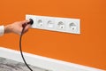 Man plugging cord into a electrical outlet Royalty Free Stock Photo